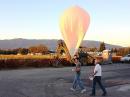 Lee and Ron walk the balloon out for launch. [Photo by Bob Snelgrove, KG6TBY]

